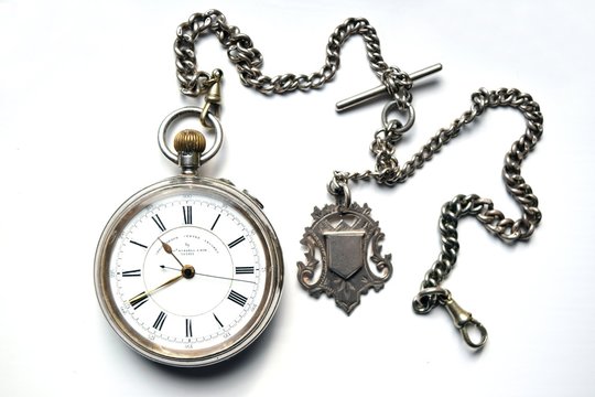 Old pocket watch with chain isolated on white