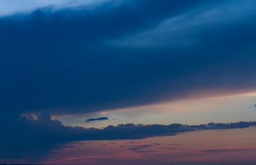 Fototapeta na wymiar Evening sky and sunset. big dark cloud