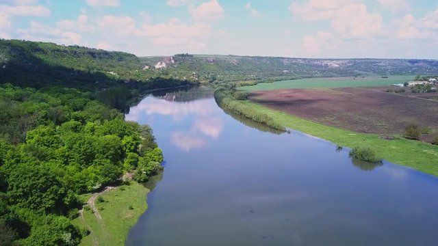 Flight over the river and forest at spring time. Dniester river of Moldova republic.