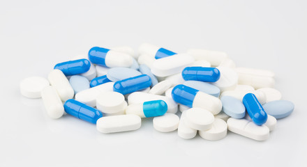 Pharmacy theme. Blue capsules and white antibiotic pills.