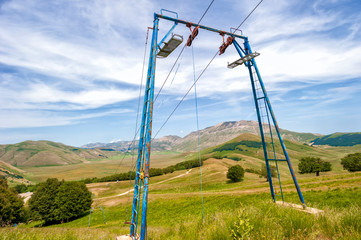 Fototapeta na wymiar old ski lift abandoned on the plateau of castelluccio di norcia, umbria italy