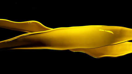 Yellow paint splashes isolated on black background.