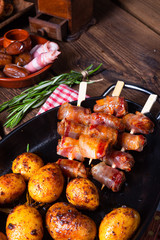 Rustic dates wrapped in bacon and young roasted potato.