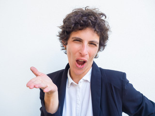 Skeptical excited businesswoman speaking and gesturing. Short haired young woman in office jacket...