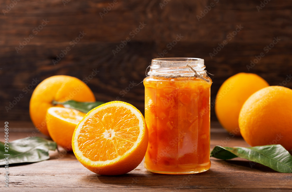 Wall mural glass jar of orange  jam with fresh fruits