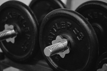 Obraz na płótnie Canvas bw macro shot of heavy dumbbells in a gym