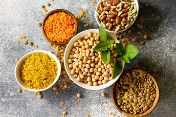 Healthy food, dieting, nutrition concept, vegan protein source. Raw of legumes (chickpeas, red lentils, canadian lentils, beans, bulgur, chickpea). Top view flat lay.