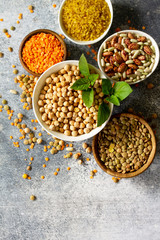 Healthy food, dieting, nutrition concept, vegan protein source. Raw of legumes (chickpeas, red lentils, canadian lentils, beans, bulgur, chickpea). Top view flat lay.