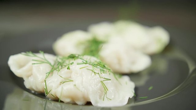 Cook sprinkles greenery on the boild dumplings