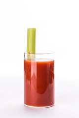 Bloody Mary alcoholic cocktail in glass garnished with celery isolated on white background