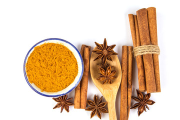 Close up the brown cinnamon stick and powder with star anise spice in wooden spoon isolated on white background