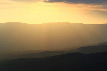 Beautiful landscape layers of mountain and Misty on hill valley in golden twilight of sunset at Thailand