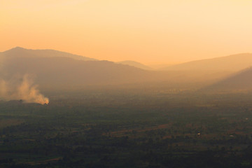 Beautiful landscape layers of mountain and Misty on hill valley in golden twilight of sunset at Thailand