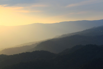 Beautiful landscape layers of mountain and Misty on hill valley in golden twilight of sunset at Thailand