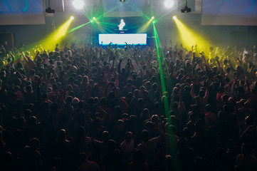 large crowd of people at a stadium concert in the dark