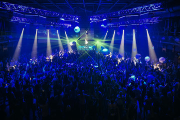 large crowd of people at a stadium concert in the dark