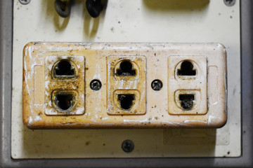  Old damaged power plugs on the wall
