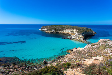 Fototapeta na wymiar Lampedusa Island Sicily - Rabbit Beach and Rabbit Island Lampedusa “Spiaggia dei Conigli” with turquoise water and white sand at paradise beach.