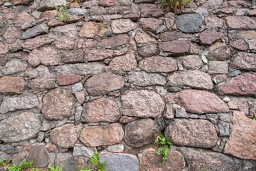 medieval ancient wall made of small stone boulders Dry stone