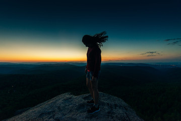 Hiker woman standing on the top mountain
