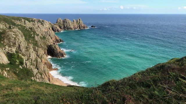 Beautiful golden sandy beach and deep blue turquoise sea in Cornish cove