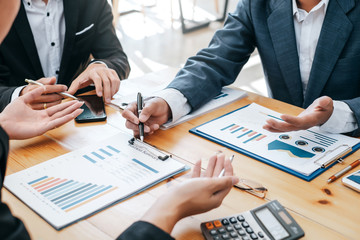 Business people meeting together about investment and the discussion graph financial information at...