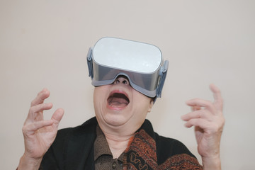 old senior woman wearing virtual reality goggles. VR headset device