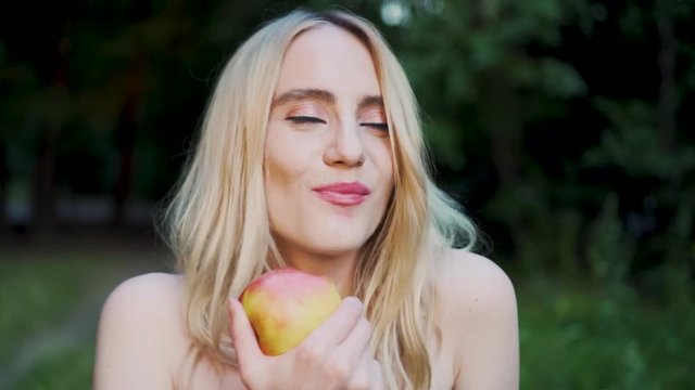 Beautiful Caucasian Blonde Girl Eating Devour Apple Asking "Wanna Bite?"