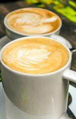 Two coffees with heart served on a plate
