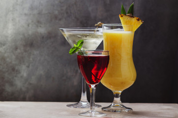 Various types of cocktails on dark background