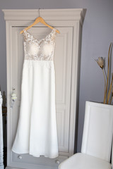 Wedding dress hanging  in the wedding boutique