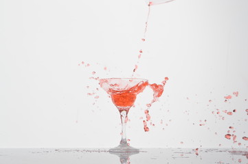 red cocktail splash in a glass