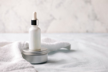 Herbal skin care cosmetics and beauty concept. White facial Serum or oil bottle and cream. Minimal...