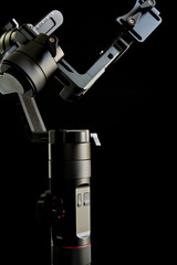 Close-up of gimbal stabilizer, with low-key lighting and a black background