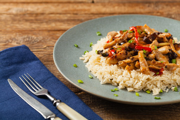 Pork chop with peppers, mushrooms and bamboo. Served with rice.