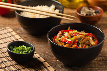 Pork chop with peppers, mushrooms and bamboo. Served with rice.