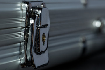 Extreme close-up of locked metal briefcase