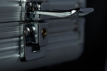 Macro of unlocked metal briefcase