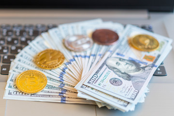 bitcoin, chart and us dollar. Finance trading. Dollar bills laying on a laptop with bitcoin charts on a blurred background