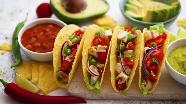 Tasty Mexican meat tacos served with various vegetables and salsa