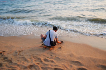 man on the beach collecting shells