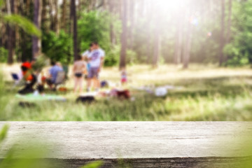 Table background with wooden table top for an advertising product. tress, forest and gardens outside the house.