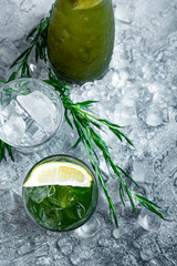 Estragon lemonade. Concept refreshing summer drinks. Fresh cool lemonade tarragon with ice and citrus slices.
