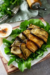 Delicious fish baked with vegetables in an eggplant grilled on a stone or slate table.
