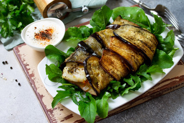 Delicious fish baked with vegetables in an eggplant grilled on a stone or slate table.