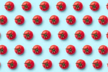 Cherry tomatoes on colored background. Pattern of cherry tomatoes. Vegans concept. Composition of tomatoes