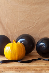 Halloween pumpkin and air balloons on the table