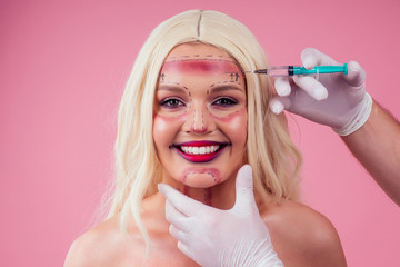 Pretty blonde barbie woman in medical beauticians hands with syringes making botox injection in her face closeup lines