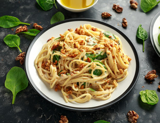 Pasta with roasted walnut, ricotta white pesto sauce, parmesan cheese and spinach