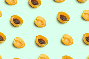 Fototapeta na wymiar Apricots on a colored background. Pattern of a apricots. Apricots isolated, flat lay, top view
